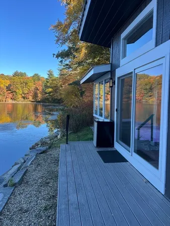 a view of a balcony with wooden floor and lake view