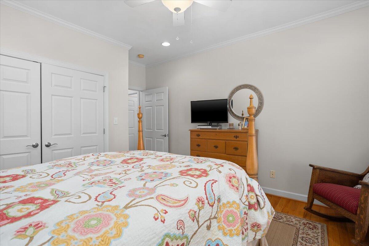 360 Maple Ridge Lane Fincastle, VA 24090 - Photo 28 of 77 a bedroom with a bed and a chair with chandelier