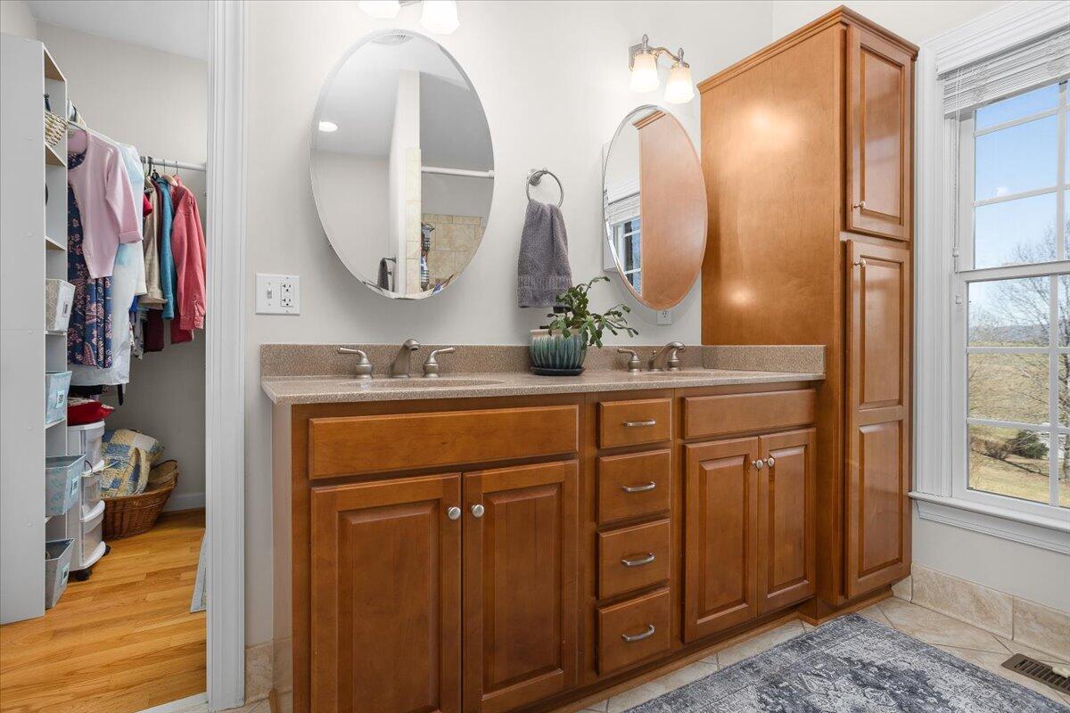 360 Maple Ridge Lane Fincastle, VA 24090 - Photo 31 of 77 a bathroom with a double vanity sink and a mirror