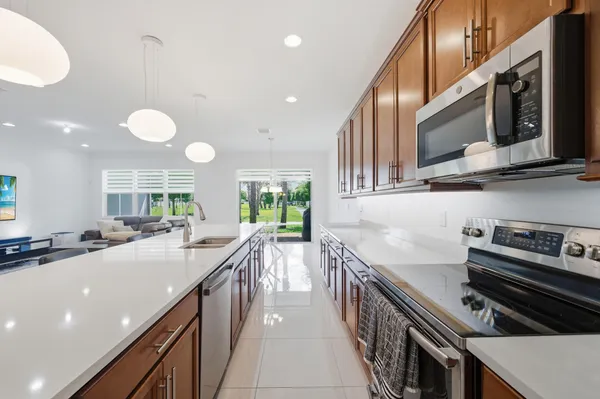 a kitchen with stainless steel appliances a sink a stove and cabinets