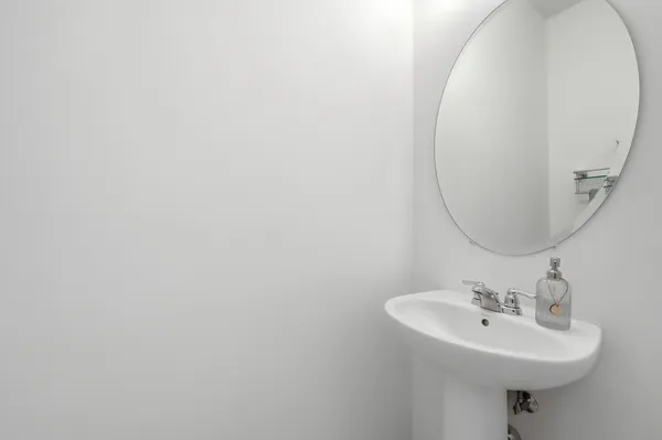 a bathroom with a sink a mirror and a toilet
