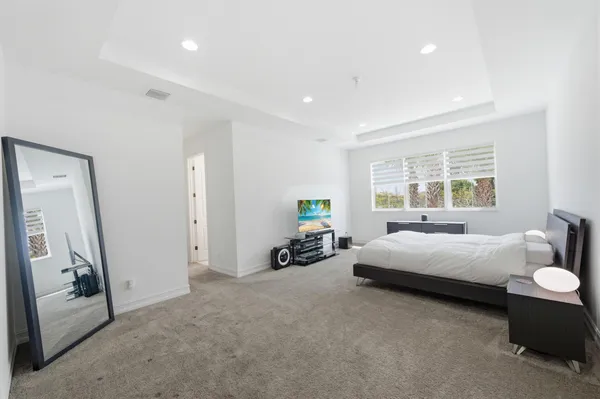 a bedroom with a bed and a night stand