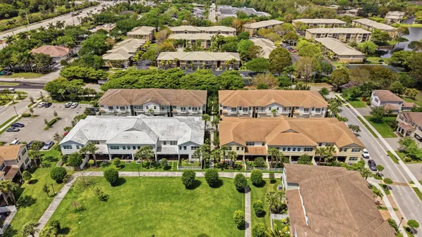 an aerial view of residential houses with outdoor space