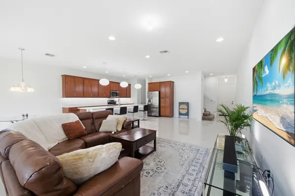 a living room with furniture and a potted plant