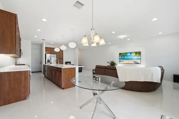 a living room with kitchen island furniture and a chandelier