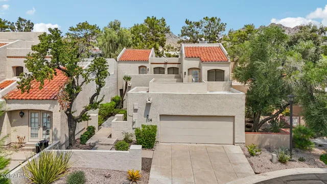 an aerial view of a house with a yard and potted plants
