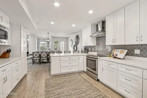 a spacious bedroom with a bed and a lamp