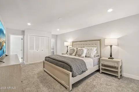 a bathroom with double vanity and a mirror