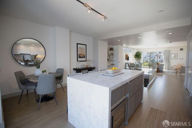 a living room with furniture a dining table and a large window