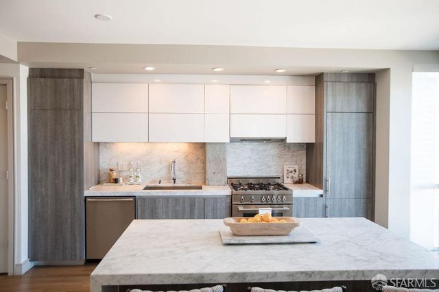 a kitchen with a refrigerator and a sink