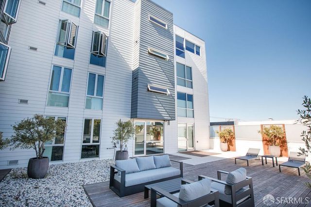 a view of a patio with couches and potted plants