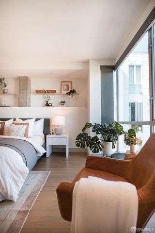 a bedroom with furniture and a large window