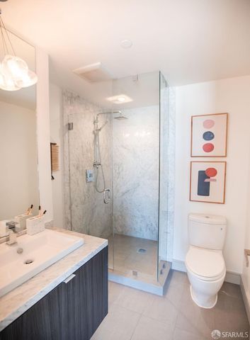 a bathroom with a toilet sink and shower