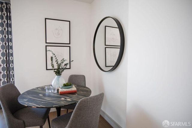 a dining room with furniture and a mirror