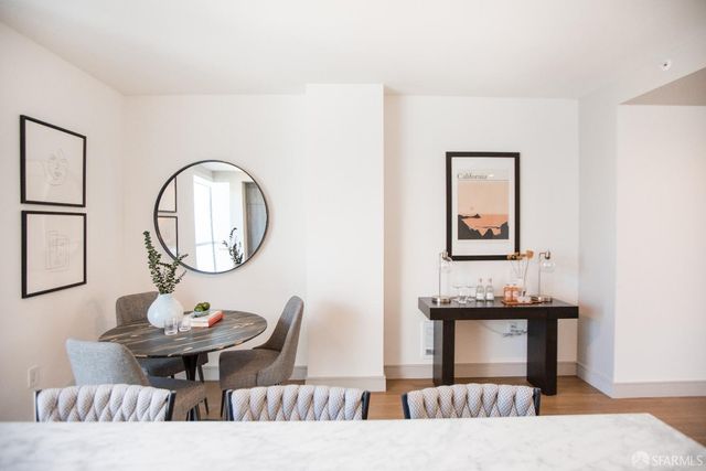 a living room with furniture a mirror and a table