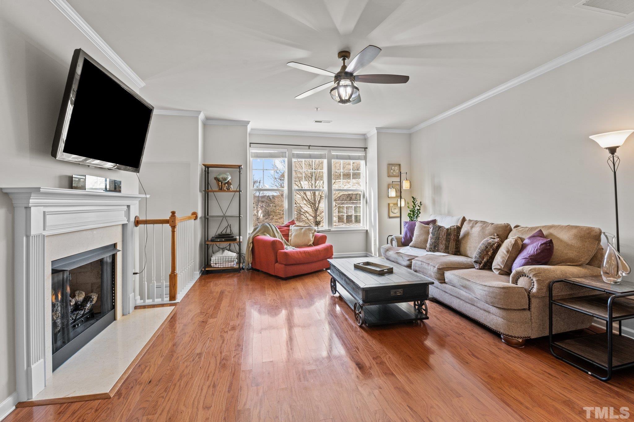 6104 Braidwood Court Raleigh, NC 27612 - Photo 12 of 31 a living room with furniture fireplace and flat screen tv