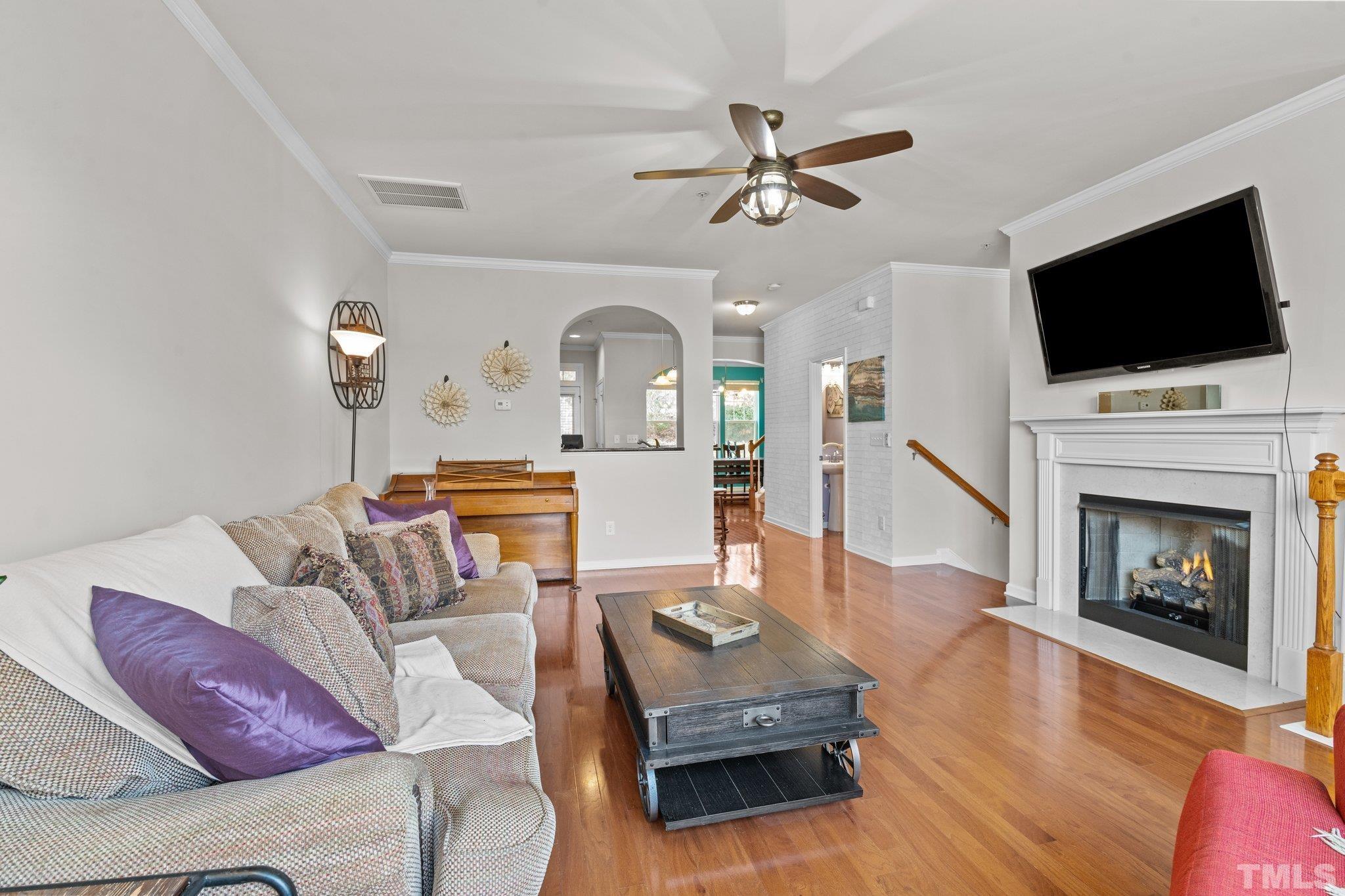 6104 Braidwood Court Raleigh, NC 27612 - Photo 13 of 31 a living room with furniture fireplace and flat screen tv