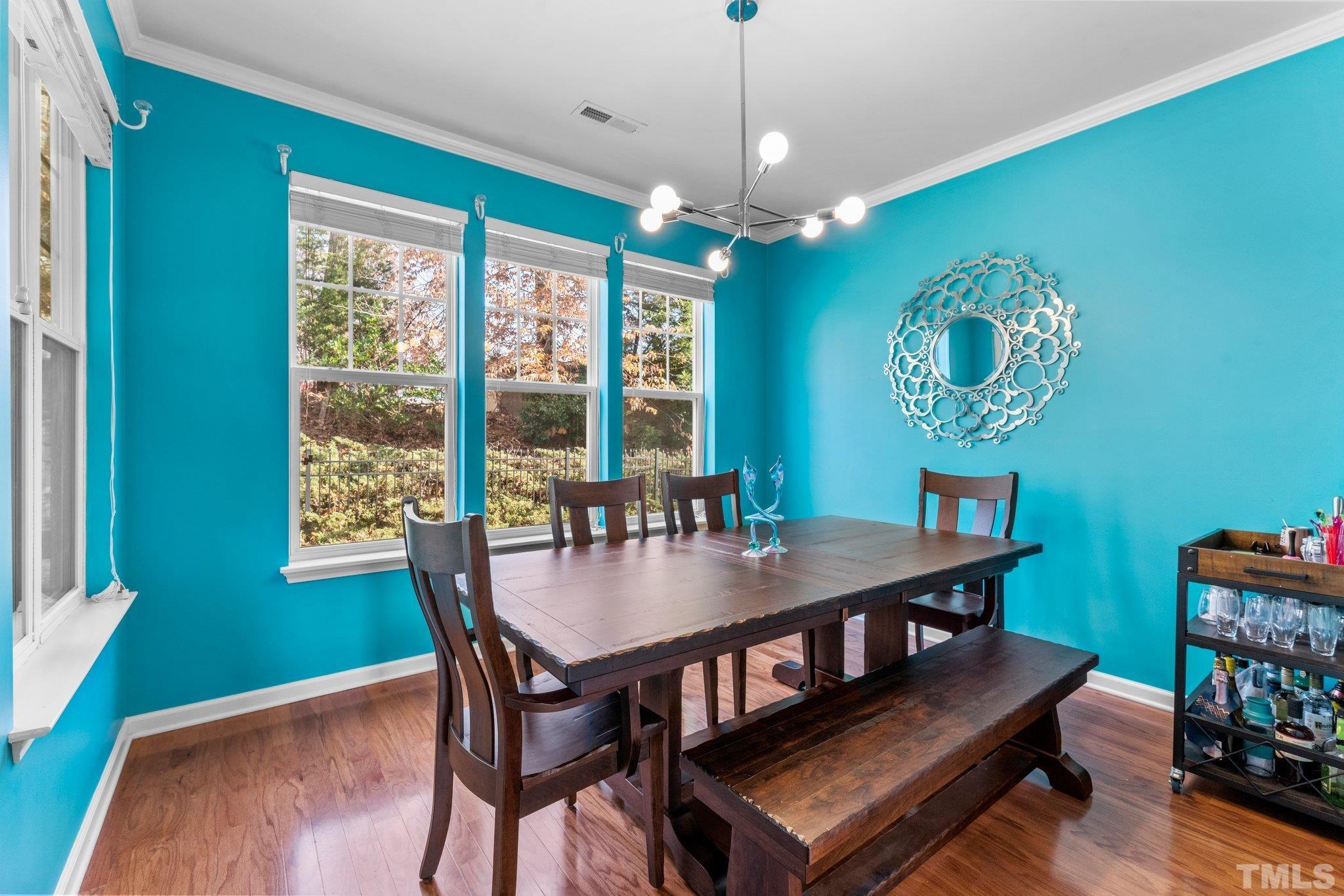 6104 Braidwood Court Raleigh, NC 27612 - Photo 16 of 31 a view of a dining room with furniture window and wooden floor