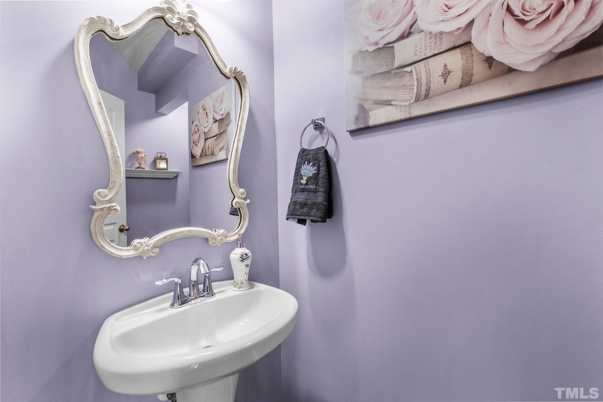 6104 Braidwood Court Raleigh, NC 27612 - Photo 18 of 31 a bathroom with a sink and mirror