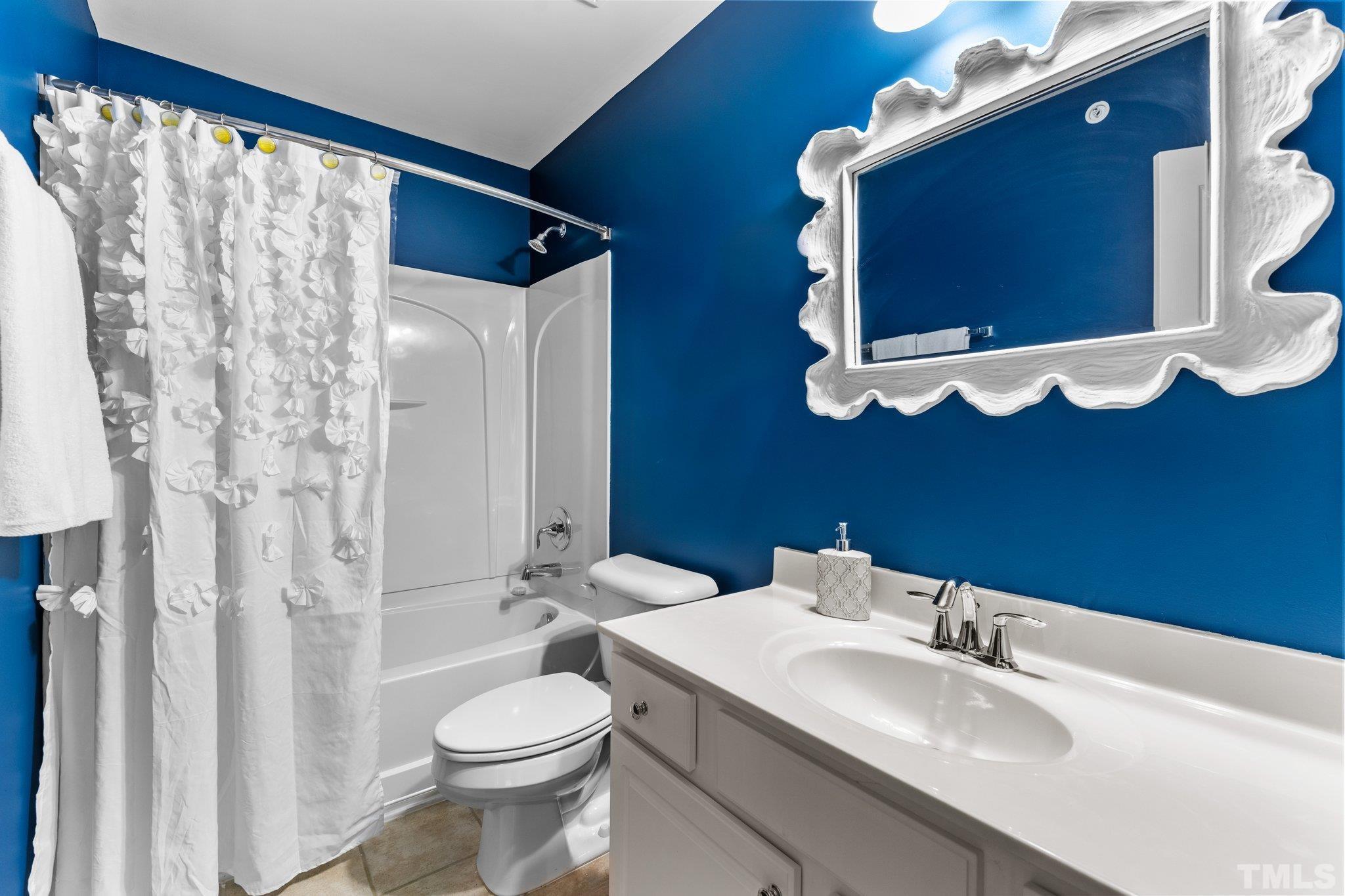 6104 Braidwood Court Raleigh, NC 27612 - Photo 21 of 31 a bathroom with a sink vanity mirror and toilet