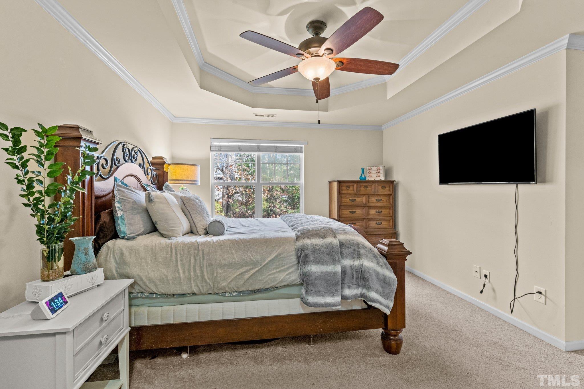 6104 Braidwood Court Raleigh, NC 27612 - Photo 24 of 31 a bedroom with a bed and a flat screen tv