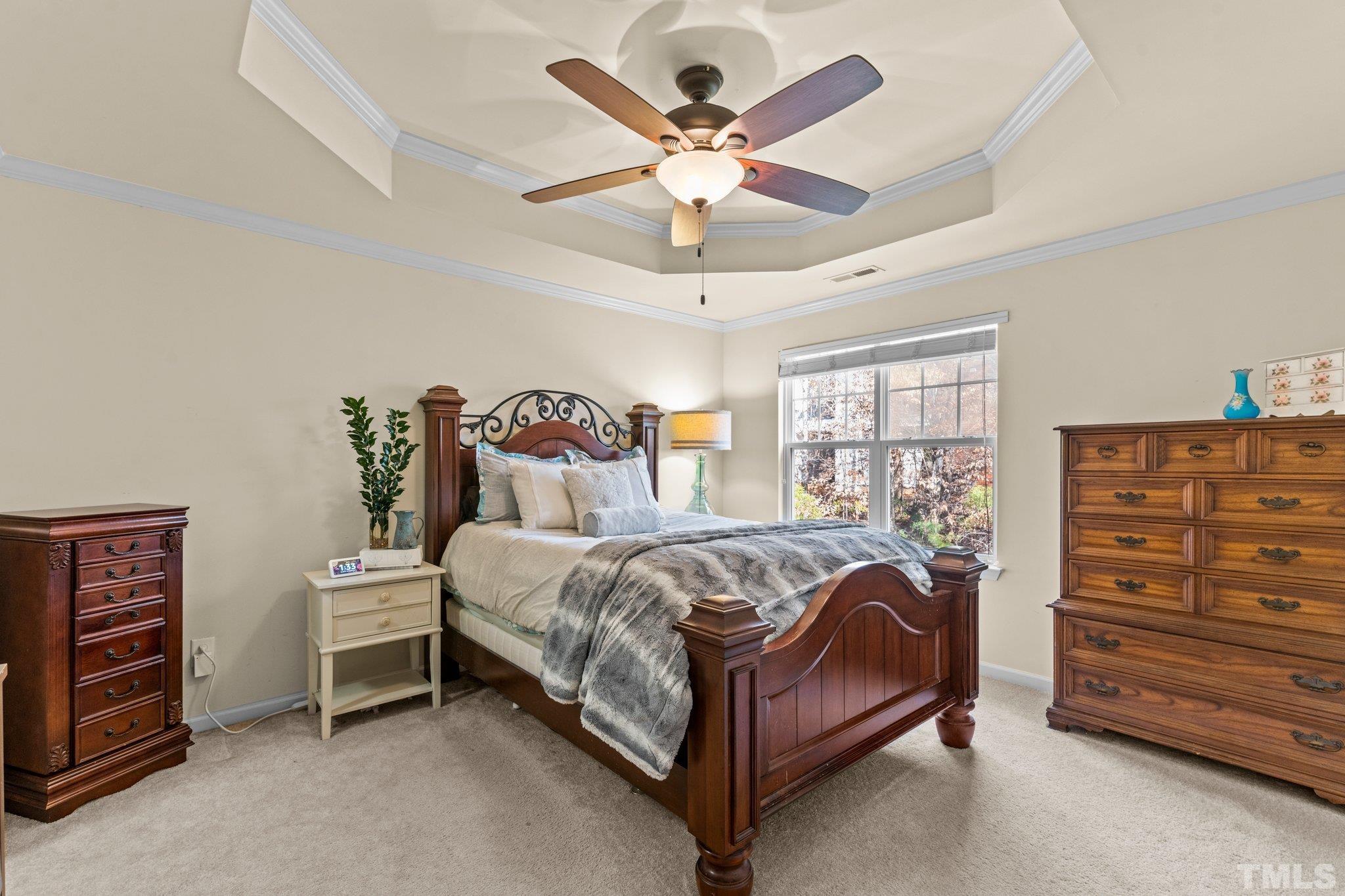 6104 Braidwood Court Raleigh, NC 27612 - Photo 25 of 31 a bedroom with a bed and a dresser