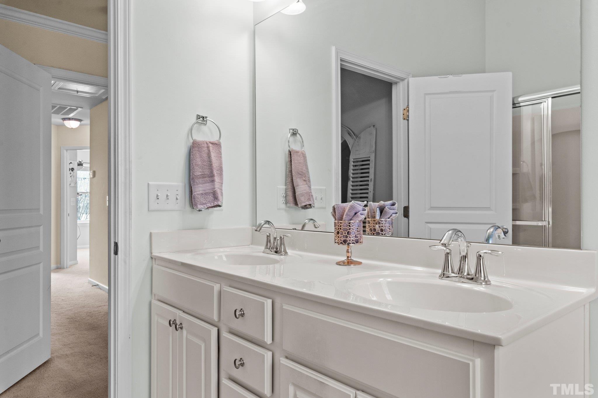 6104 Braidwood Court Raleigh, NC 27612 - Photo 27 of 31 a bathroom with a double vanity sink mirror and
