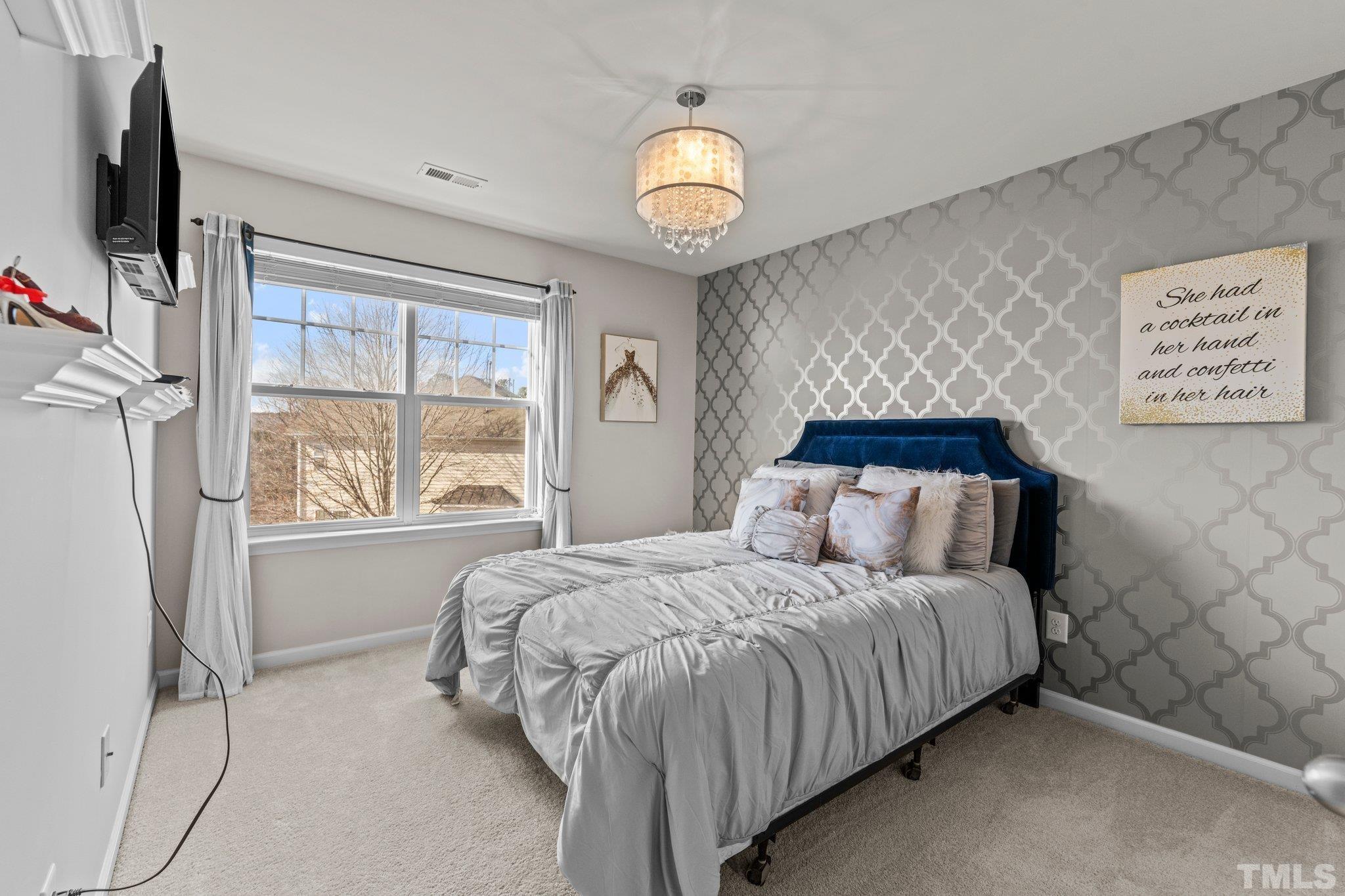 6104 Braidwood Court Raleigh, NC 27612 - Photo 6 of 31 a bedroom with a bed and a window