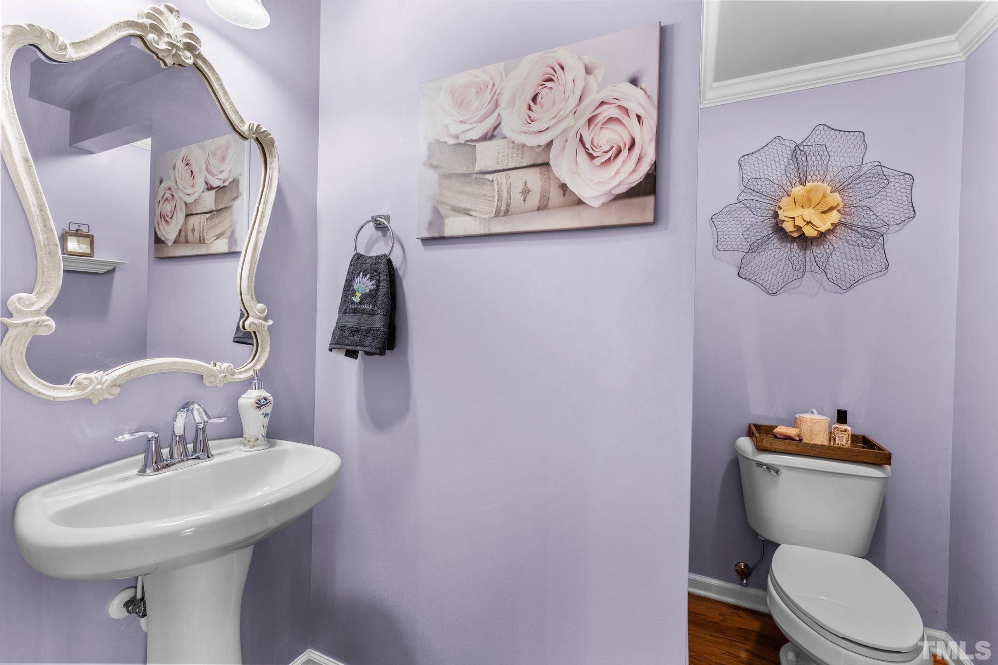 6104 Braidwood Court Raleigh, NC 27612 - Photo 7 of 31 a bathroom with a toilet sink and mirror