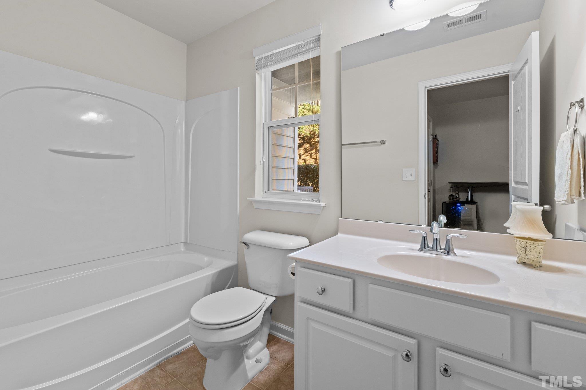 6104 Braidwood Court Raleigh, NC 27612 - Photo 10 of 31 a bathroom with a sink toilet and shower