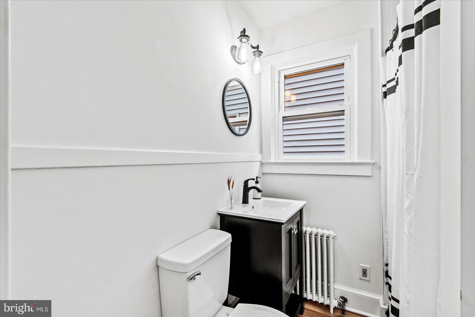 1312 Rowe Street Fredericksburg, VA 22401 - Photo 20 of 45 a bathroom with a sink a toilet and a mirror