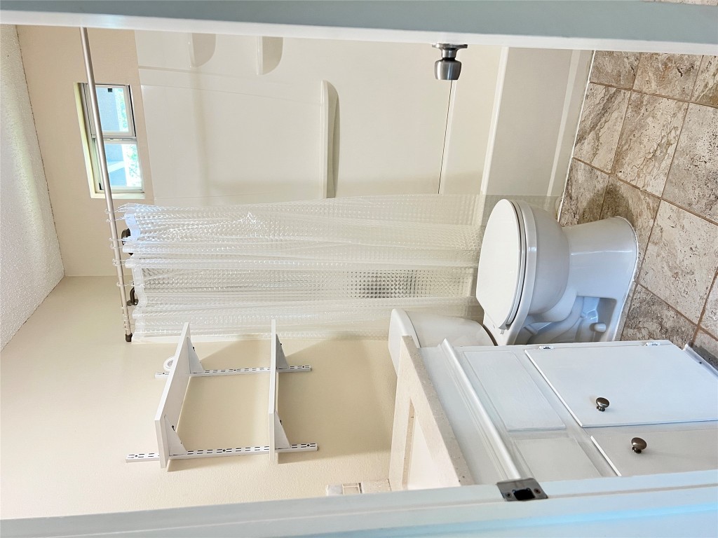 3112 Govalle Avenue, Unit B Austin, TX 78702 - Photo 4 of 7 a bathroom with a toilet and a shower