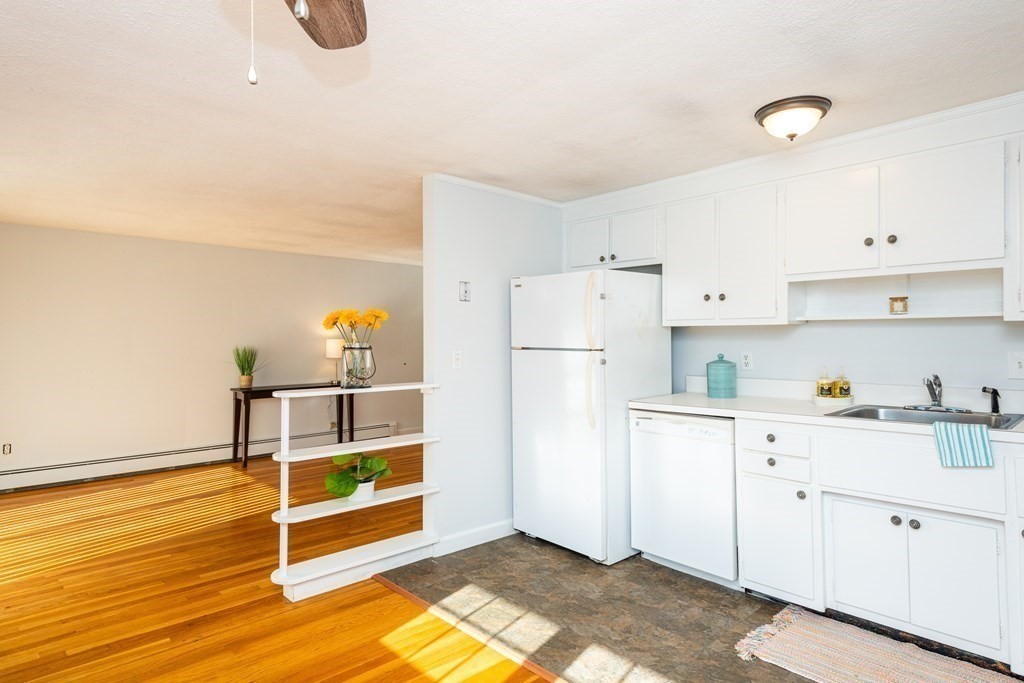 82 Renwick Road, Unit A Wakefield, MA 01880 - Photo 16 of 34 a kitchen with refrigerator and cabinets