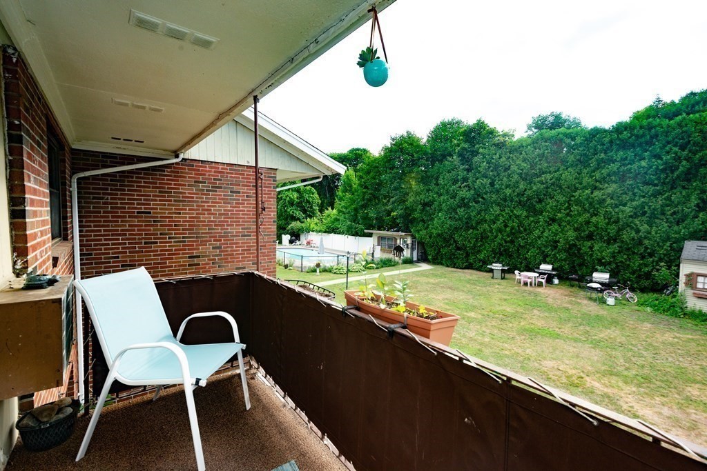 82 Renwick Road, Unit A Wakefield, MA 01880 - Photo 27 of 34 a backyard of a house with table and chairs