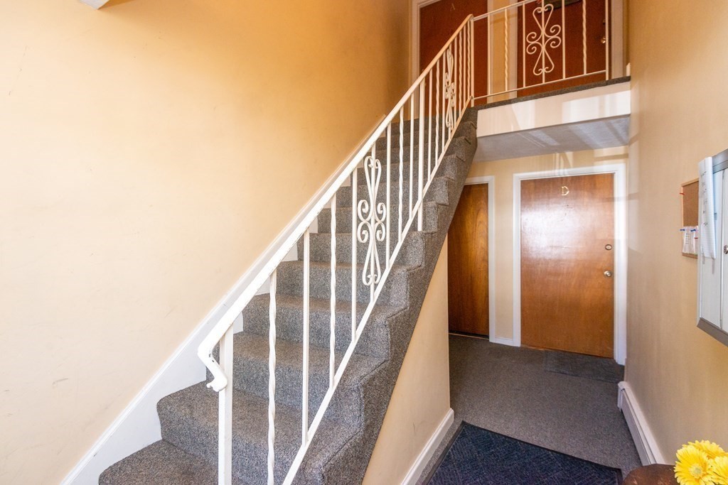 82 Renwick Road, Unit A Wakefield, MA 01880 - Photo 3 of 34 a view of staircase with wooden floor and white walls