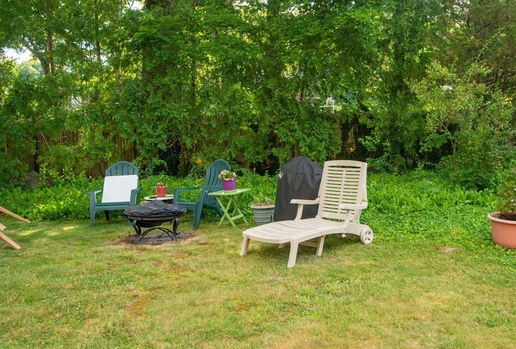 82 Renwick Road, Unit A Wakefield, MA 01880 - Photo 34 of 34 a garden with a bench and some trees