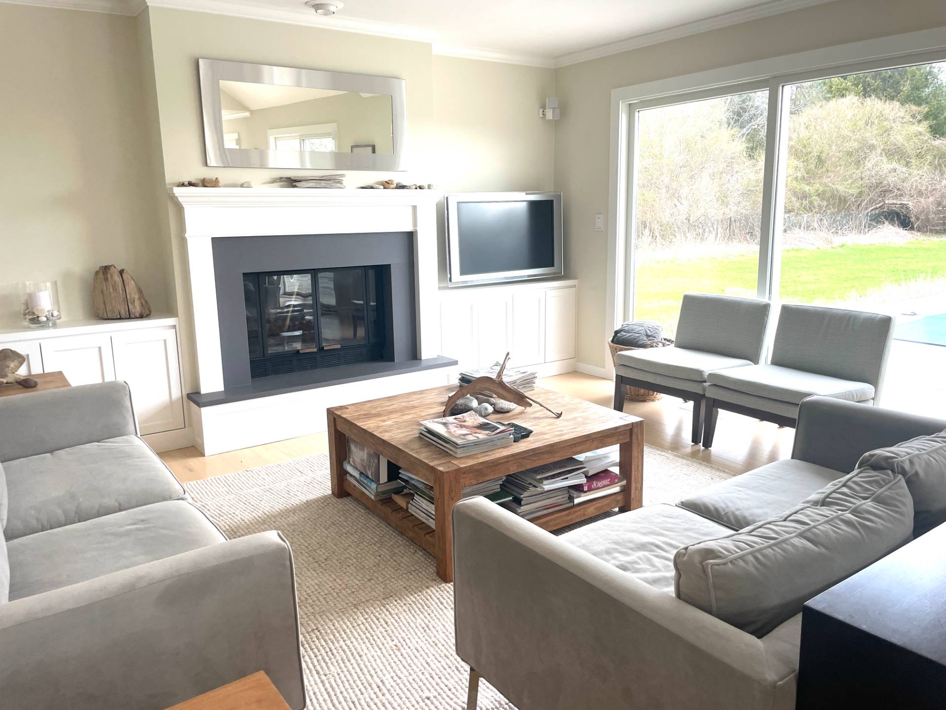 761 North Sea Mecox Road Southampton, NY 11968 - Photo 11 of 22 a living room with furniture a large window and a fireplace