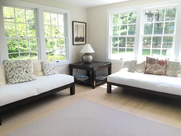a large bed sitting in a bedroom next to a window
