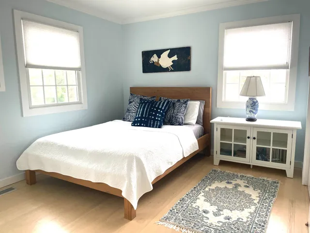 a view of a bedroom with bed and window