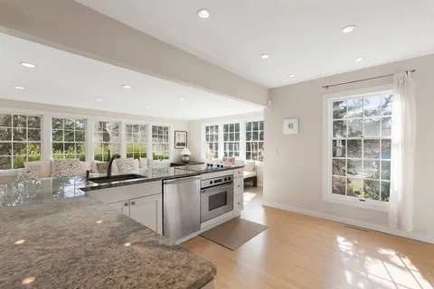a kitchen with a stove a refrigerator and a counter top space