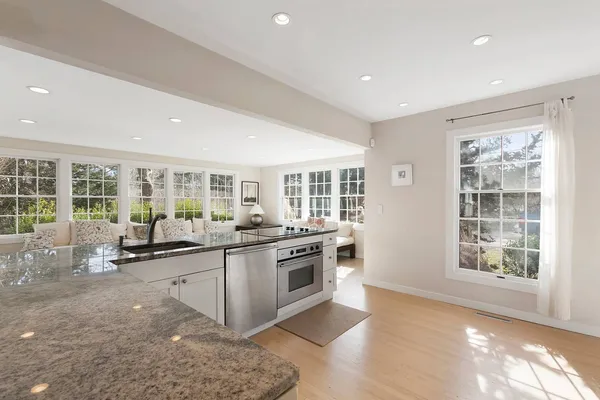 a kitchen with a stove a refrigerator and a counter top space