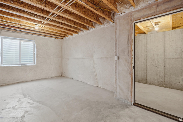 730 West 500 North Smithfield, UT 84335 - Photo 28 of 46 Unfinished lower level featuring exposed ceiling joists, concrete flooring, and a sliding window