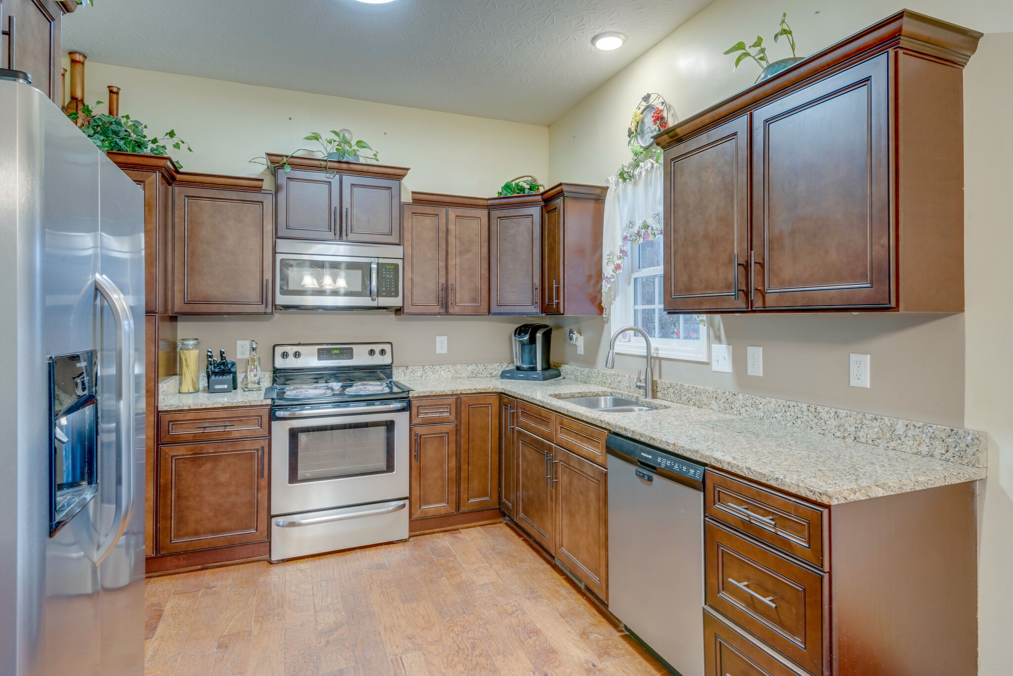 8990 New Chapel Road Springfield, TN 37172 - Photo 8 of 25 a kitchen with stainless steel appliances granite countertop a sink stove and refrigerator