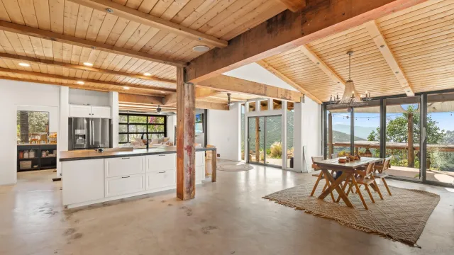 a dining room with wooden floor and furniture