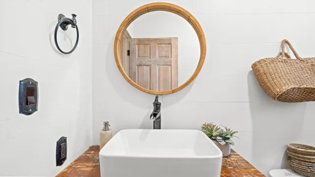 a bathroom with a sink a mirror and a toilet