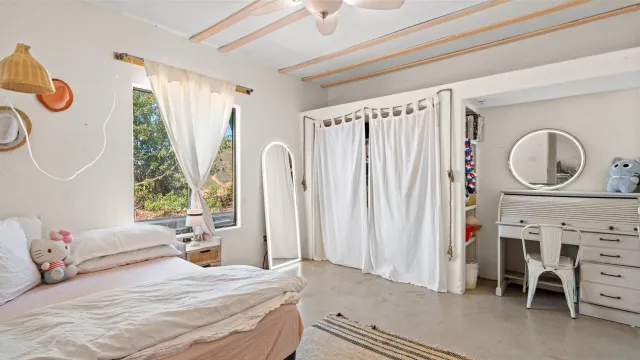 a bedroom with a bed and a window