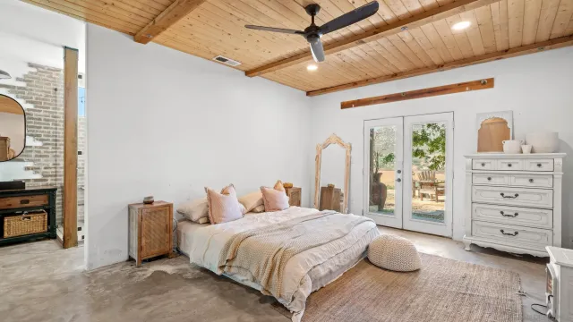 a spacious bedroom with a bed and a cabinets