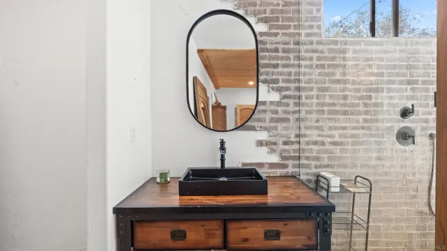 a room with a sink and a mirror