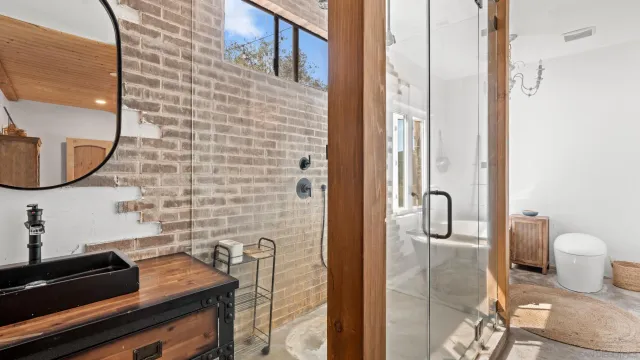 a bathroom with a sink a toilet and mirror