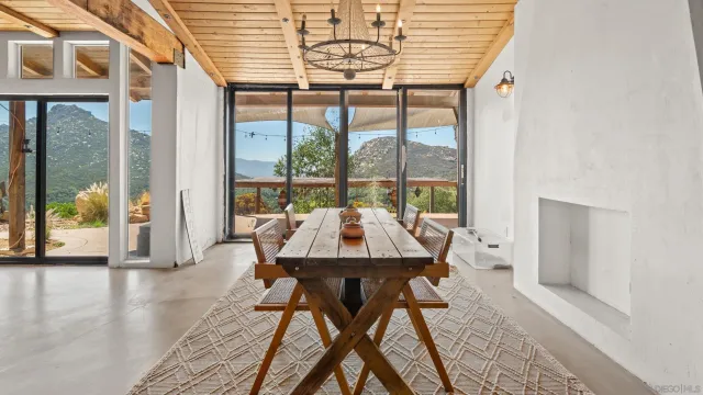 a view of a dining room with furniture wooden floor and a chandelier